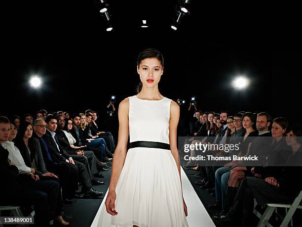 model walking in foreground on catwalk - fashion show ストックフォトと画像