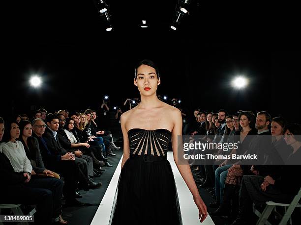 model walking in foreground on catwalk - diversity showcase arrivals stock pictures, royalty-free photos & images