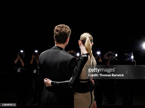 two celebrities being photographed by paparazzi - adulation stock pictures, royalty-free photos & images