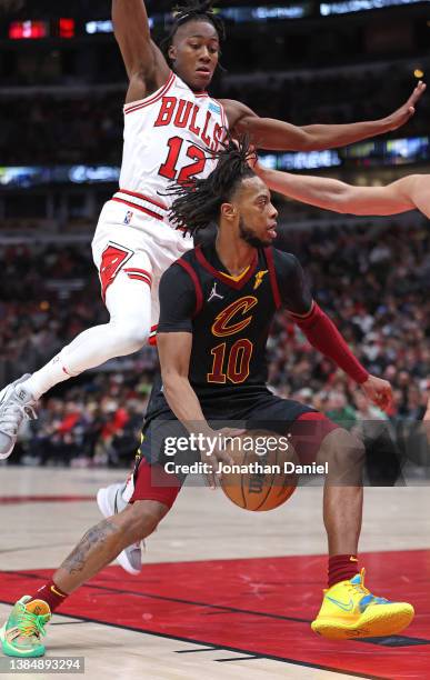 Tim Frazier of the Cleveland Cavaliers moves against Ayo Dosunmu of the Chicago Bulls at the United Center on March 12, 2022 in Chicago, Illinois....