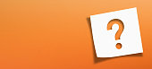 Note paper with question mark on panoramic orange background