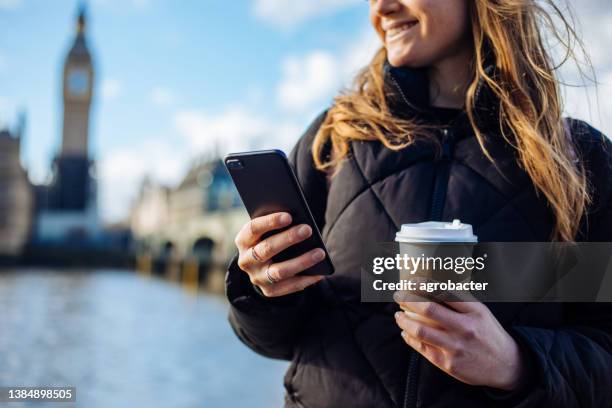 beautiful woman using phone on the street in london - inner london stock pictures, royalty-free photos & images