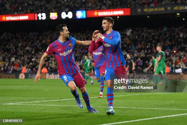 Ferran Torres of FC Barcelona celebrates with teammate Sergio Busquets after scoring their team's first goal during the LaLiga Santander match...