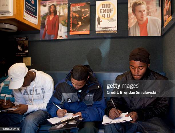 People fill out paperwork before getting tested for HIV during a free HIV testing event at by the Whitman-Walker Health February 7, 2012 in...