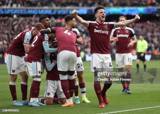 Declan Rice celebrates Andriy Yarmolenko of West Ham United's first goal during the Premier League match between West Ham United and Aston Villa at...