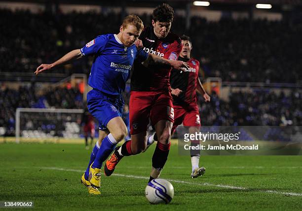 Chris Burke of Birmingham City battles with Greg Halford of Portsmouth during the npower Championship match between Birmingham City and Portsmouth at...