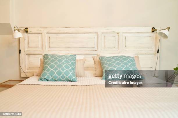 wooden headboard with blue pillow in a stylish trendy decoration with copy space - headboard stock pictures, royalty-free photos & images