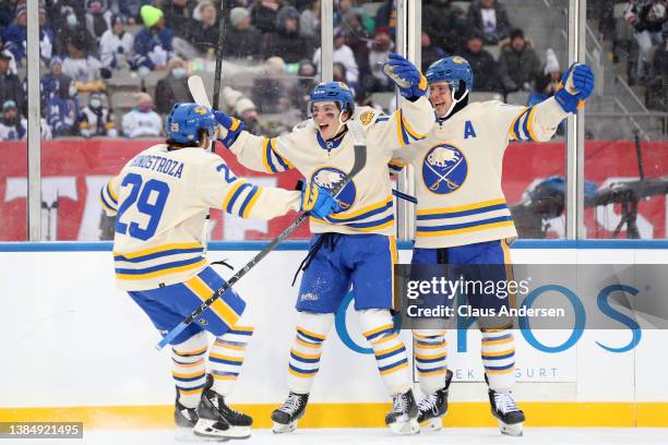 Vinnie Hinostroza, Peyton Krebs and Mark Pysyk of the Buffalo Sabres celebrate a goal against the Toronto Maple Leafs in the second period during the...