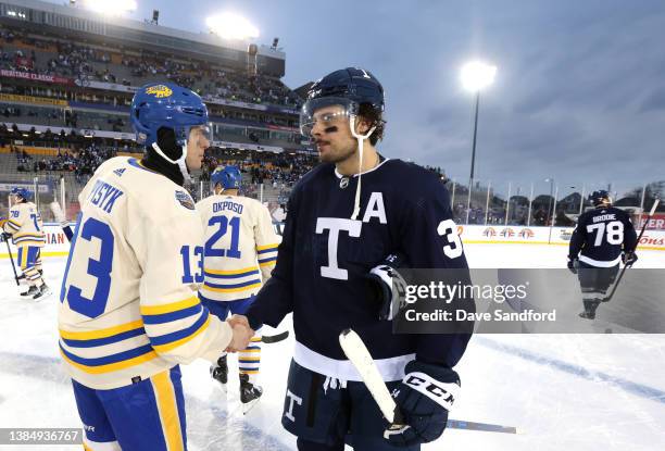 Auston Matthews of the Toronto Maple Leafs and Mark Pysyk of the Buffalo Sabres shake hands after the 2022 Tim Hortons NHL Heritage Classic between...