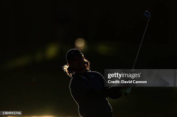 Tommy Fleetwood of England plays his second shot on the par 4, seventh hole as the sun goes down during completion of the weather delayed third round...