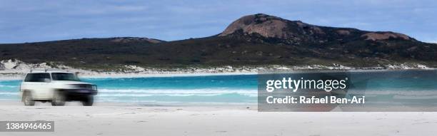 4wd vehicle driving on white sands in lucky bay western australia - driving car australia road copy space sunlight travel destinations colour image day getting stock pictures, royalty-free photos & images