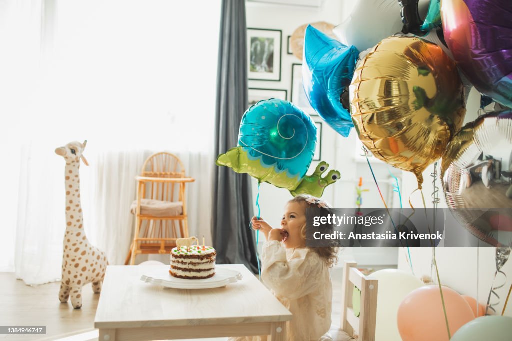 Young girl blowing candles for celebreating her 2th years birthday.