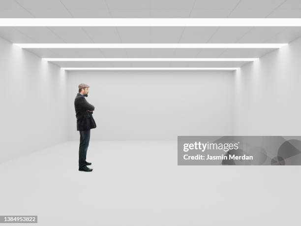man standing in empty room - attic storage stockfoto's en -beelden