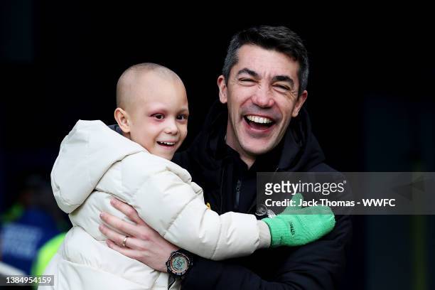 Bruno Lage, Manager of Wolverhampton Wanderers celebrates victory with young football fan, River following the Premier League match between Everton...