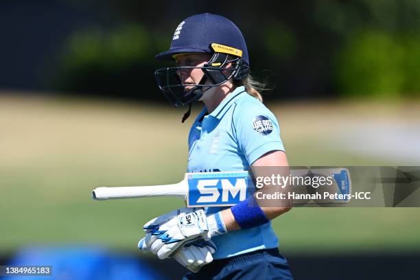 Heather Knight of England looks dejected while leaving the field of play after being bowled out by Marizanne Kapp of South Africa during the 2022 ICC...