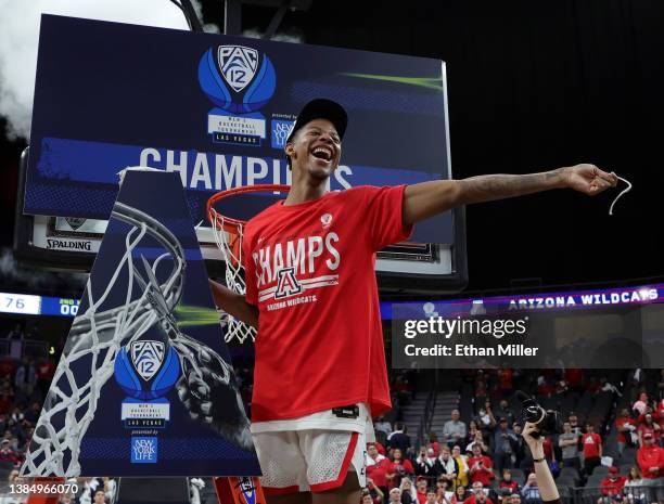 Dalen Terry of the Arizona Wildcats celebrates after cutting a piece of a basketball net following the team's 84-76 victory over the UCLA Bruins to...