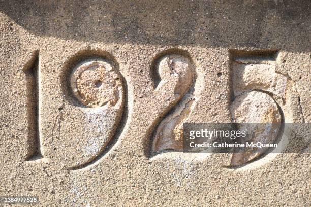 imprint of the year “1925” on church’s stone wall - victory parish stock pictures, royalty-free photos & images