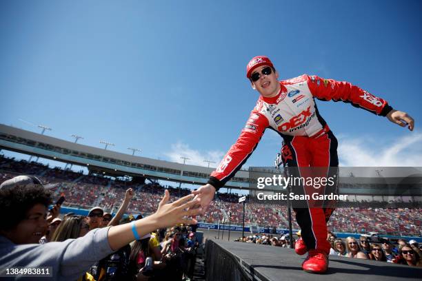 Harrison Burton, driver of the DEX Imaging Ford, greets fans during the driver intros prior to the Ruoff Mortgage 500 at Phoenix Raceway on March 13,...