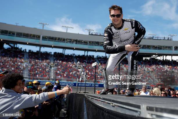 Landon Cassill, driver of the Voyager: Crypto for All Chevrolet, greets fans during the driver intros prior to the Ruoff Mortgage 500 at Phoenix...