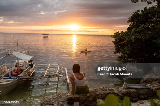 kayaking at sunset on danjugan island, negros occidental, philippines. - negros occidental stock pictures, royalty-free photos & images