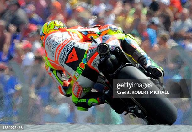 Italy's Valentino Rossi of the Ducati team steers his bike during the qualifying of the Moto Grand Prix at the Sachsenring Circuit on July 16, 2011...