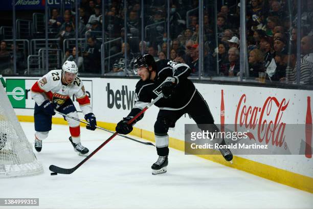 Sean Durzi of the Los Angeles Kings skates the puck against the Florida Panthers in the third period at Crypto.com Arena on March 13, 2022 in Los...