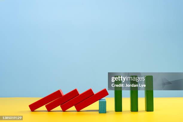 color block shape falling. solution for domino effect concept - block verteidigen stock-fotos und bilder