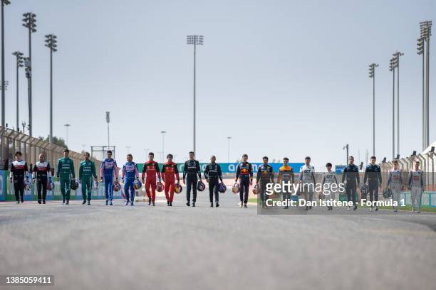 The F1 drivers pose for a photo on the grid during Day One of F1 Testing at Bahrain International Circuit on March 10, 2022 in Bahrain, Bahrain.