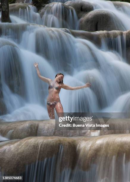 woman taking a shower under a waterfall - dunns river falls stock pictures, royalty-free photos & images