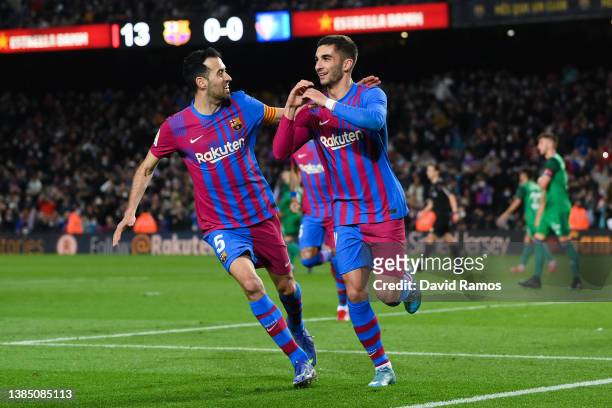 Ferran Torres of FC Barcelona celebrates with his team mates Sergio Busquets after scoring his team's first goal during the LaLiga Santander match...