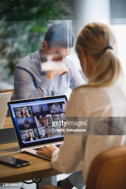 selective focus shot of young businesswoman on a group video call - two people video conferencing stock pictures, royalty-free photos & images
