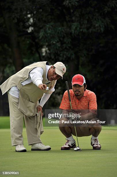 Filipino professional boxer and politician Manny Pacquiao lines up a putt during the Pro-am event ahead of the ICTSI Philippine Open at Wack Wack...