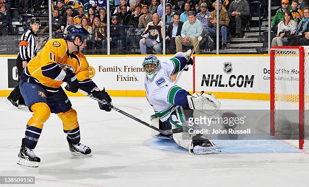David Legwand of the Nashville Predators puts the puck in the net in a shootout against Roberto Luongo of the Vancouver Canucks during an NHL game at...