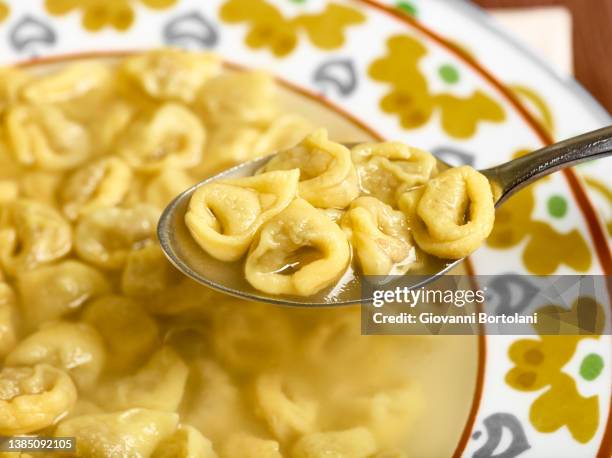 typical italian dish, with spoon - tortellini foto e immagini stock