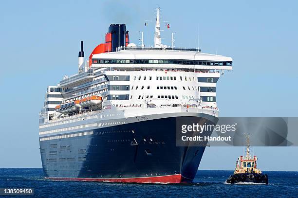 In this handout image provided by Carnival Australia, The Queen Mary 2 enters Fremantle Harbour on February 8, 2012 in Perth, Australia. Cunard's...
