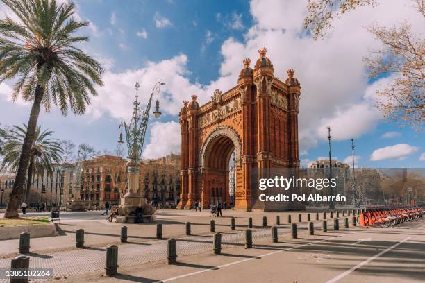 the arc de triomf or arco de triunfo in spanish, is a triumphal arch in the city of barcelona. - barceloneta beach stock pictures, royalty-free photos & images