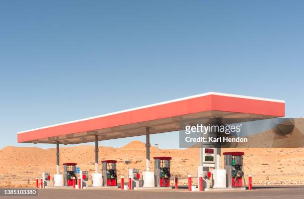 a daytime surface level view of a gas station in america - gas station ストックフォトと画像