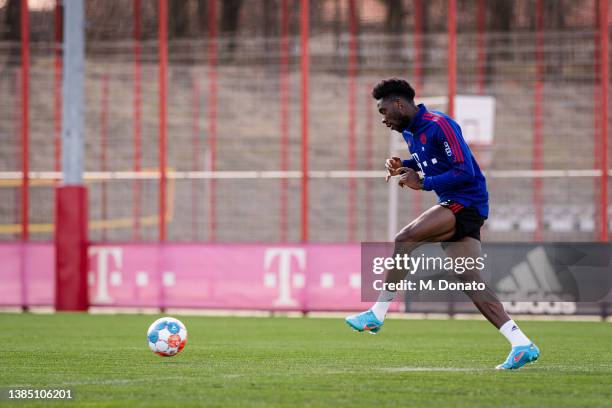 Alphonso Davies of FC Bayern Muenchen passes the ball during a rehabilitation training session at Saebener Strasse training ground on March 14, 2022...