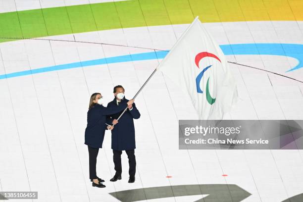 Vice Mayor of Milan Anna Scavuzzo and Mayor of Cortina d'Ampezzo Gianpietro Ghedina wave the Paralympic flag during the closing ceremony of the...