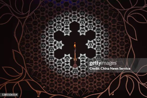 The Paralympic flame is extinguishing during the closing ceremony of the Beijing 2022 Winter Paralympics at the Beijing National Stadium on March 13,...