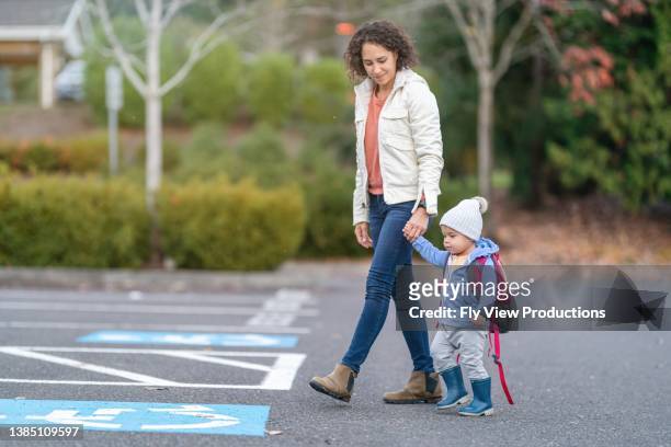 mom dropping daughter off at preschool - picking up stock pictures, royalty-free photos & images
