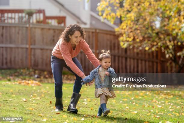 mom playing outside with her daughter - chasing toddler stock pictures, royalty-free photos & images
