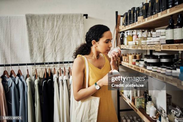 shot of a young woman shopping in an organic store - cosmetic products stock pictures, royalty-free photos & images