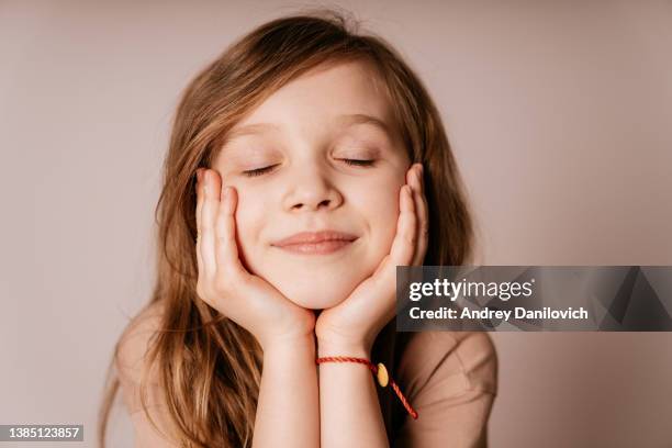 portrait of a smiling small girl with long brown hair. - face eyes closed stock pictures, royalty-free photos & images