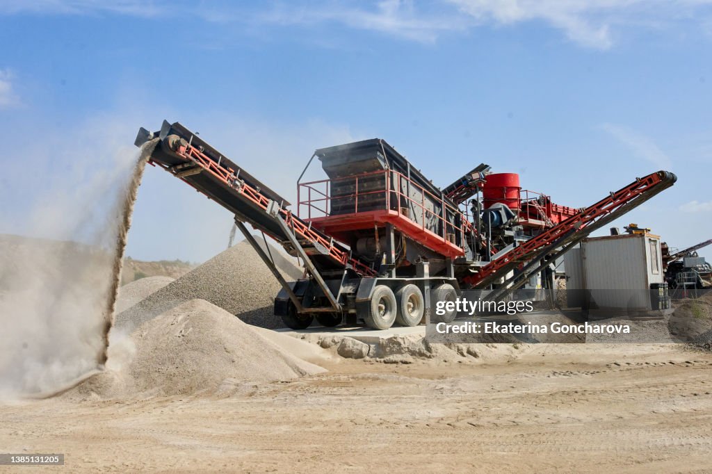 Crushing machine in a sand quarry. Summer, sunny weather