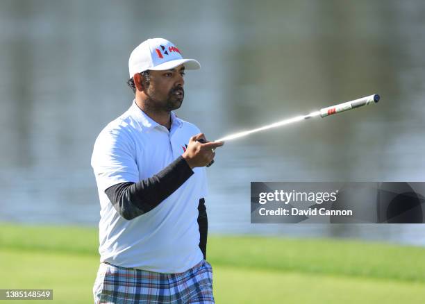 Anirban Lahiri of India walks to the green with his putter on the par 4, 18th hole during completion of the weather delayed third round of THE...