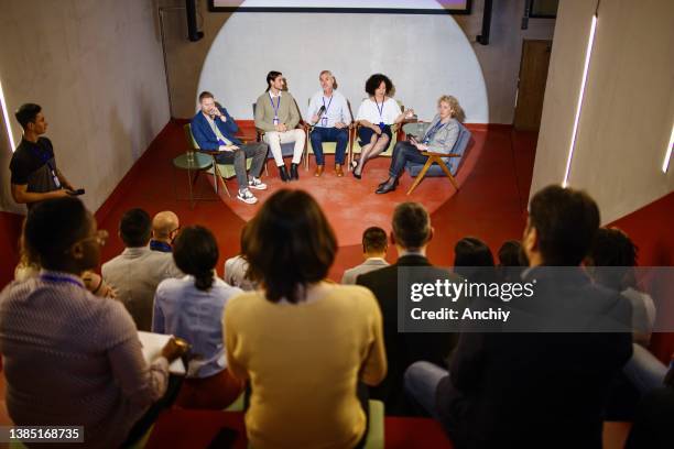 group of conference speakers participate in a panel discussion. - panel discussion stock pictures, royalty-free photos & images