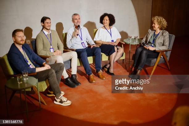 a panel of experts participate in a q&a breakout session during a business conference. - panel discussion stock pictures, royalty-free photos & images