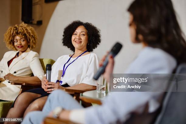 a panel of experts participate in a q&a breakout session during a business conference. - q and a panel stock pictures, royalty-free photos & images