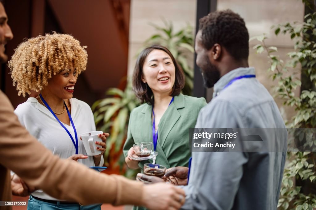 Multiethnic business people talk during a coffee break
